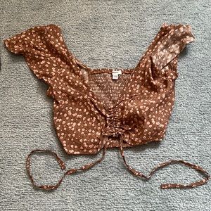 Brown ruffled + floral print top